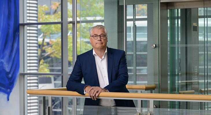 Friedrich Hubert Esser, President of tBIBB, in front of a lift in the BIBB building in Bonn